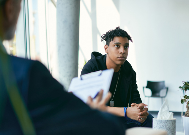 Clinician interviewing a despondent young man